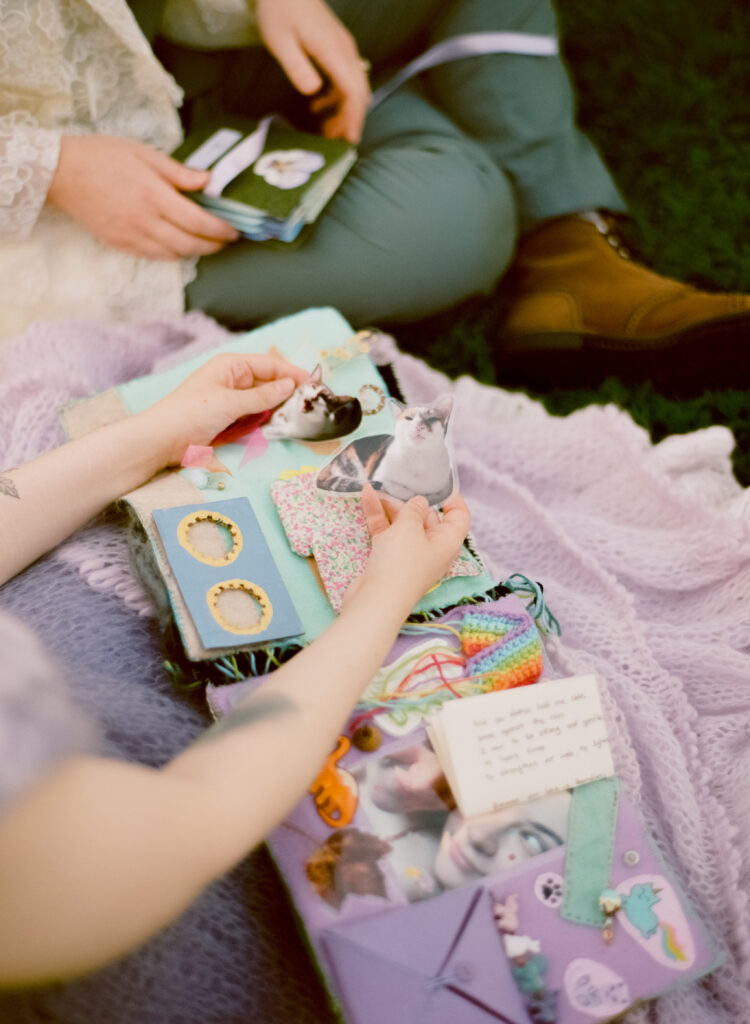 Close-up photograph of newlywed gift of a felt book, featuring stickers, felted pieces, acrylic charms, and more, encompassing the couples' life together.