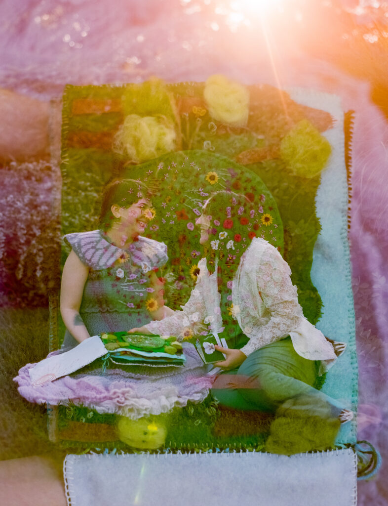 Double exposure color photograph of newlywed couple sitting and smiling together, overlayed with a felt books page featuring intricate embroidery of flowers.