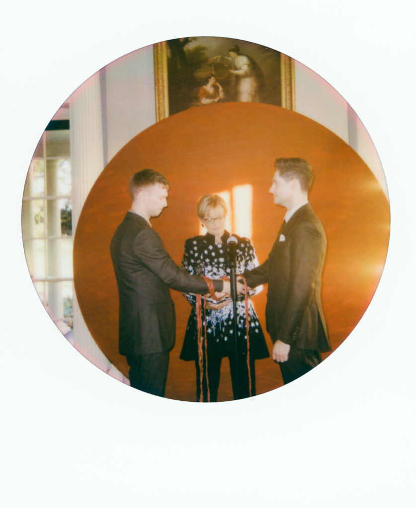 polaroid photo of a queer couple at their wedding ceremony