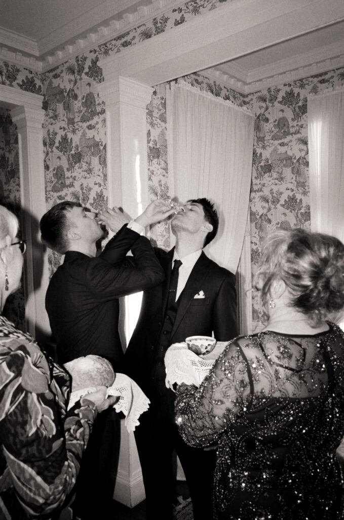 mother and grandmother do The Salt and Bread Tradition with their sons on wedding day