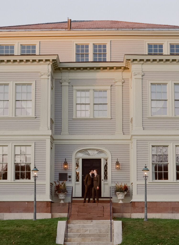 queer couple kissing outside of The Lyman Estate