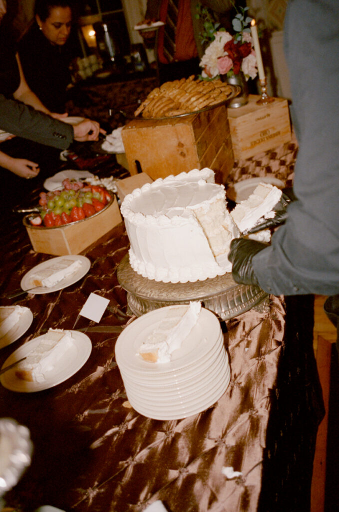 wedding cake and other treats on dessert table