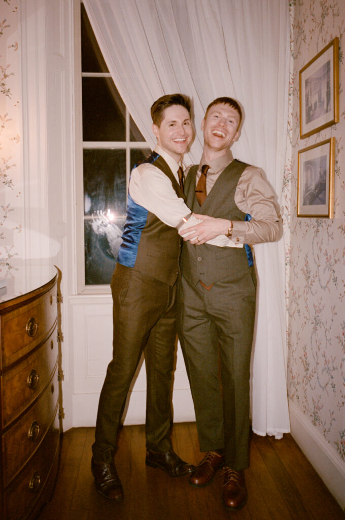 grooms smiling and hugging at the Lyman Estate