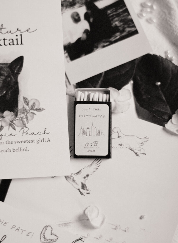 black and white wedding invitations, cards, and pictures on a bed for wedding detail photos on film for a Jewish wedding at The Omni Parker House Hotel