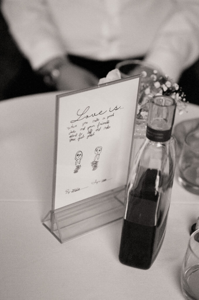 handmade table signs and bottle of alcohol on table