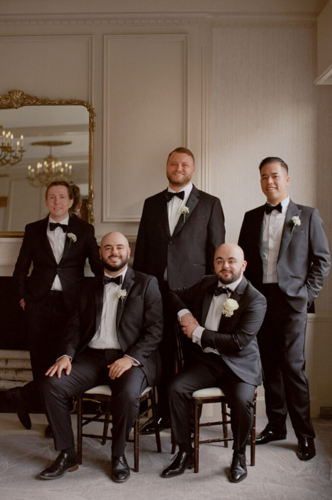 groom and groomsmen posing for a photo at a omni parker house wedding