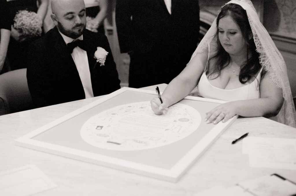 bride and groom do the ketuba signing