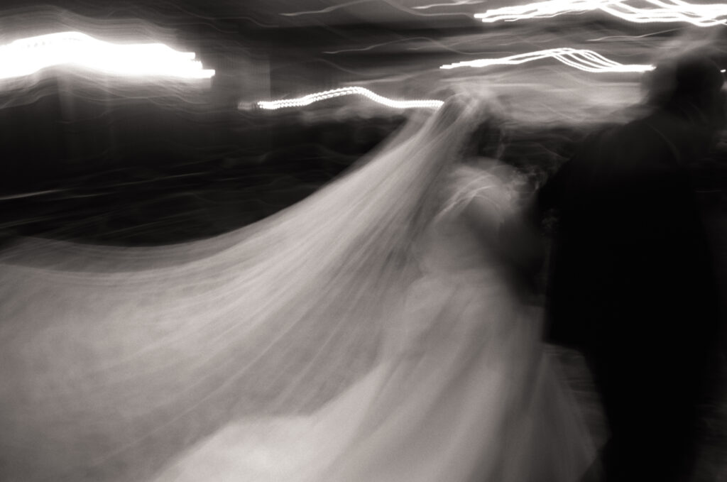 blurry black and white photo of bride walking down the aisle