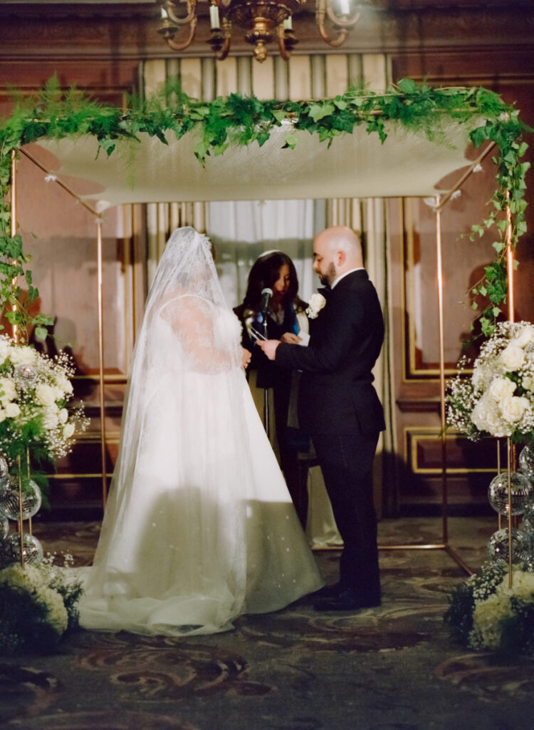 bride and groom wedding ceremony under huppah