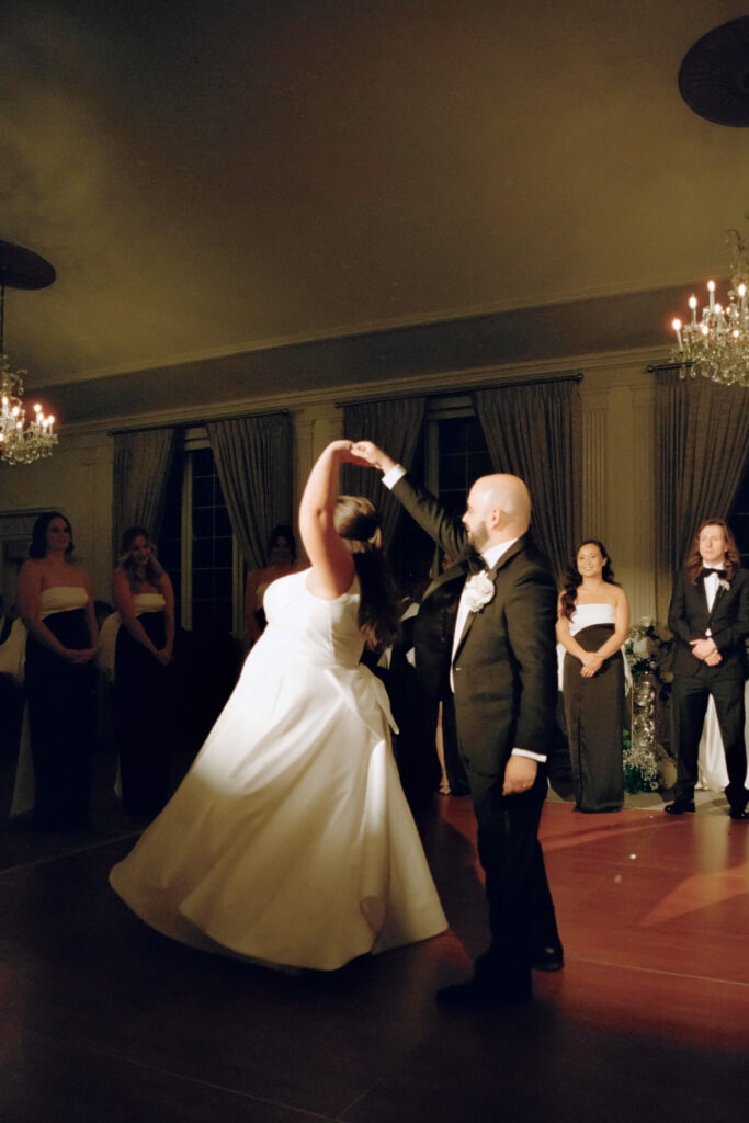 groom spinning bride during first dance