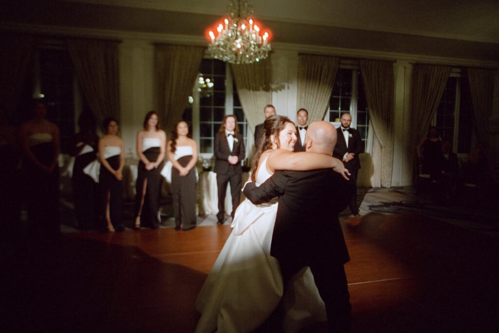 bride and groom dancing with spotlight on them during first dance