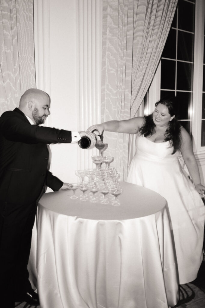 bride and groom pouring champagne on a champagne tower