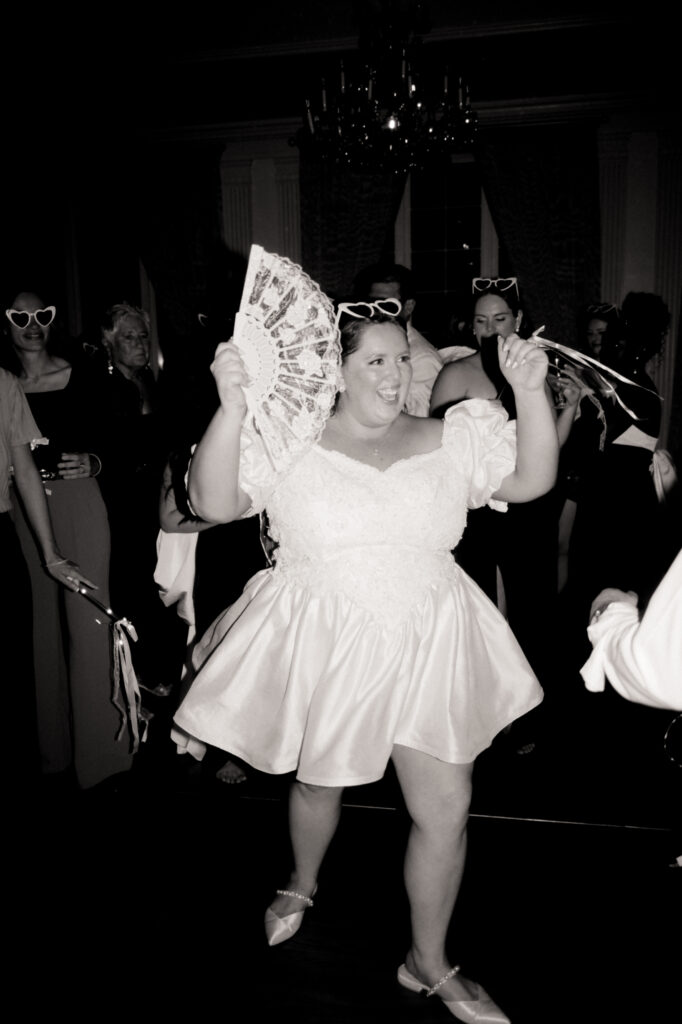 bride smiling and dancing during wedding reception