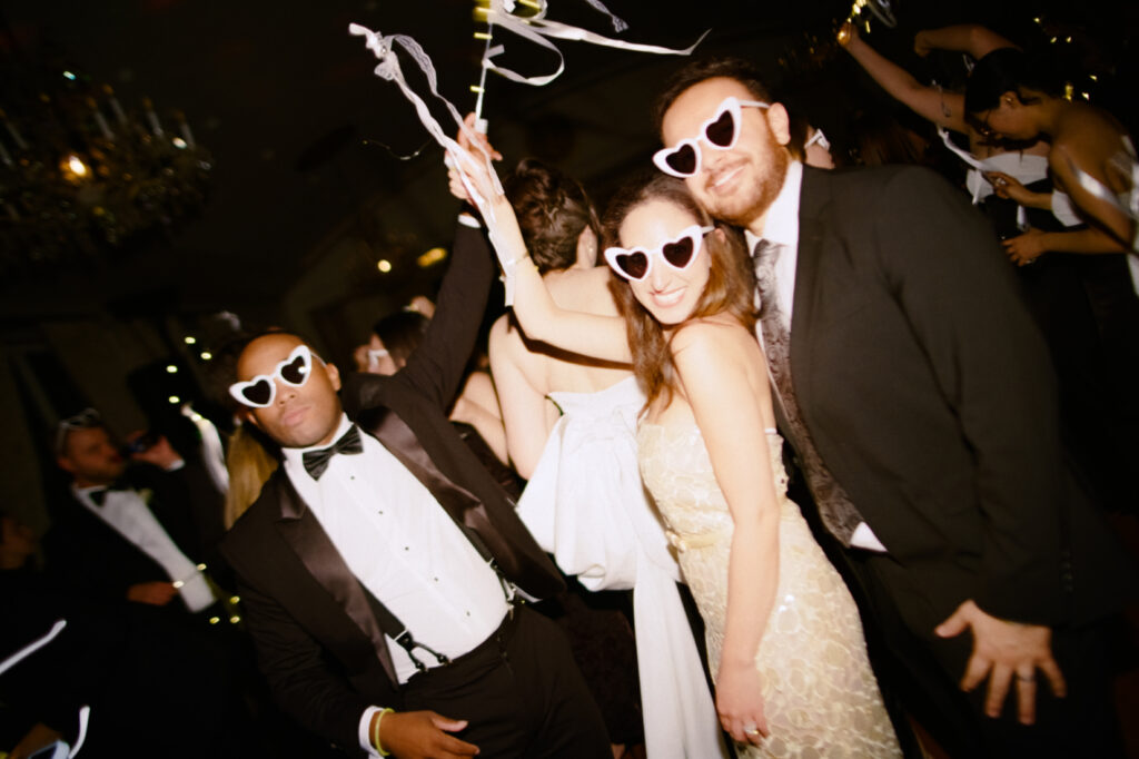 wedding guests smiling and dancing during wedding reception