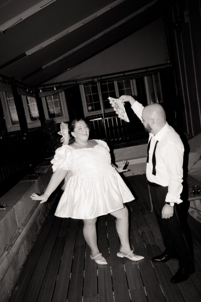 groom fanning bride in black and white photo