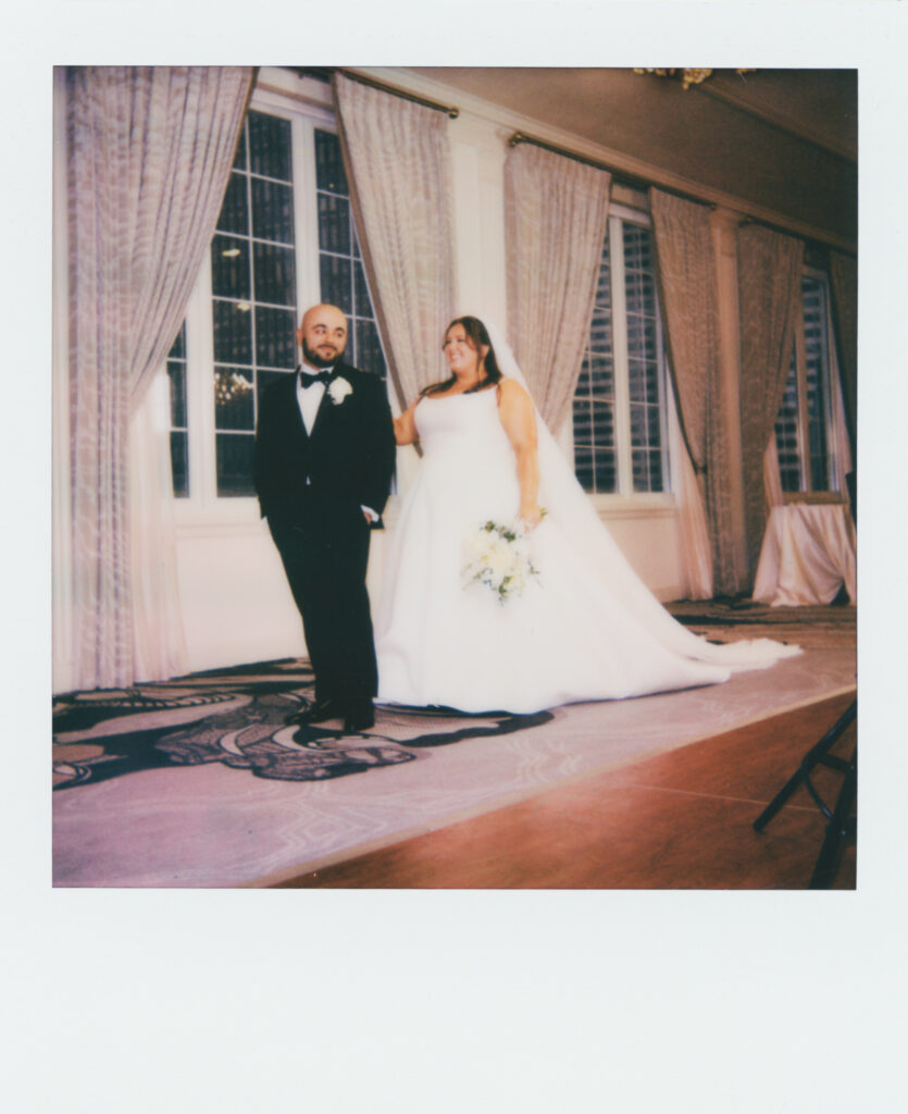 polaroid photo of bride and groom in front of window