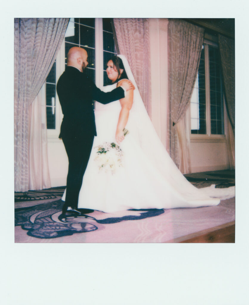 polaroid photo of bride and groom in front of window