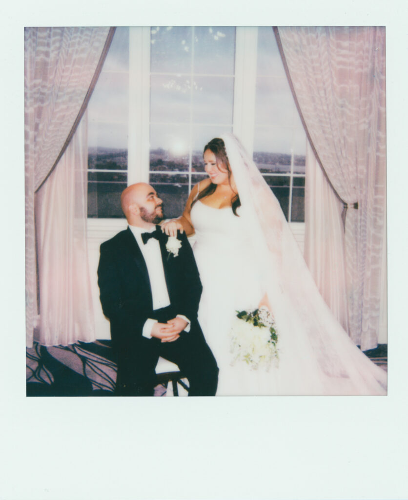 polaroid photo of bride and groom in front of window