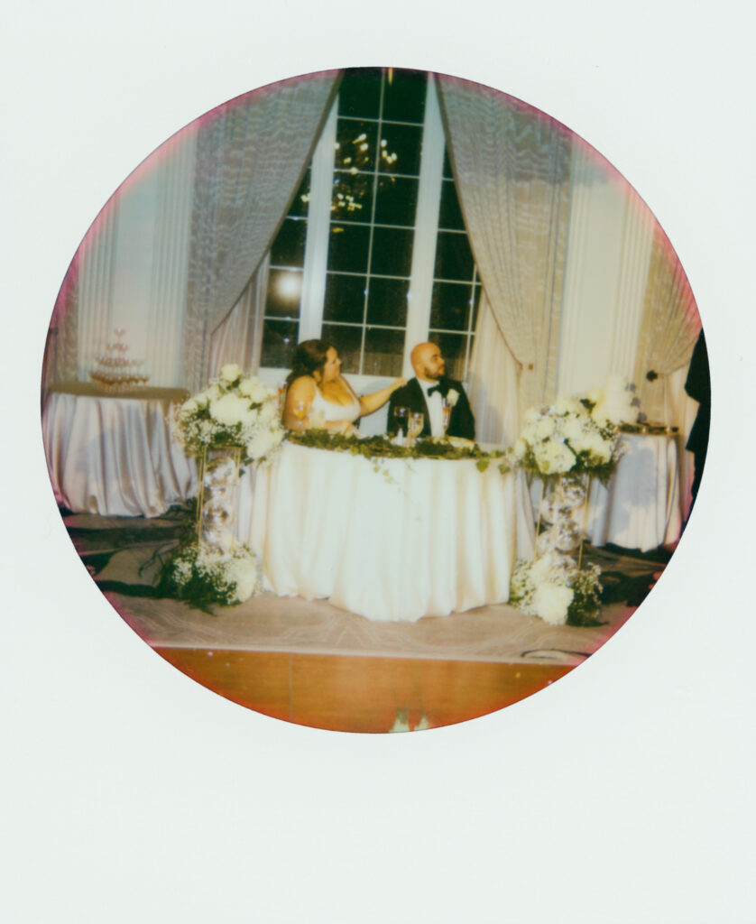 polaroid of bride and groom at sweet heart table