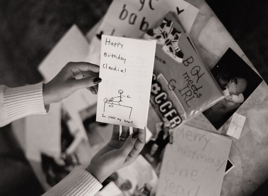 a person holding a card at a engagement shoot on film 