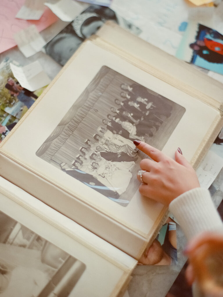 a hand pointing at a photo album