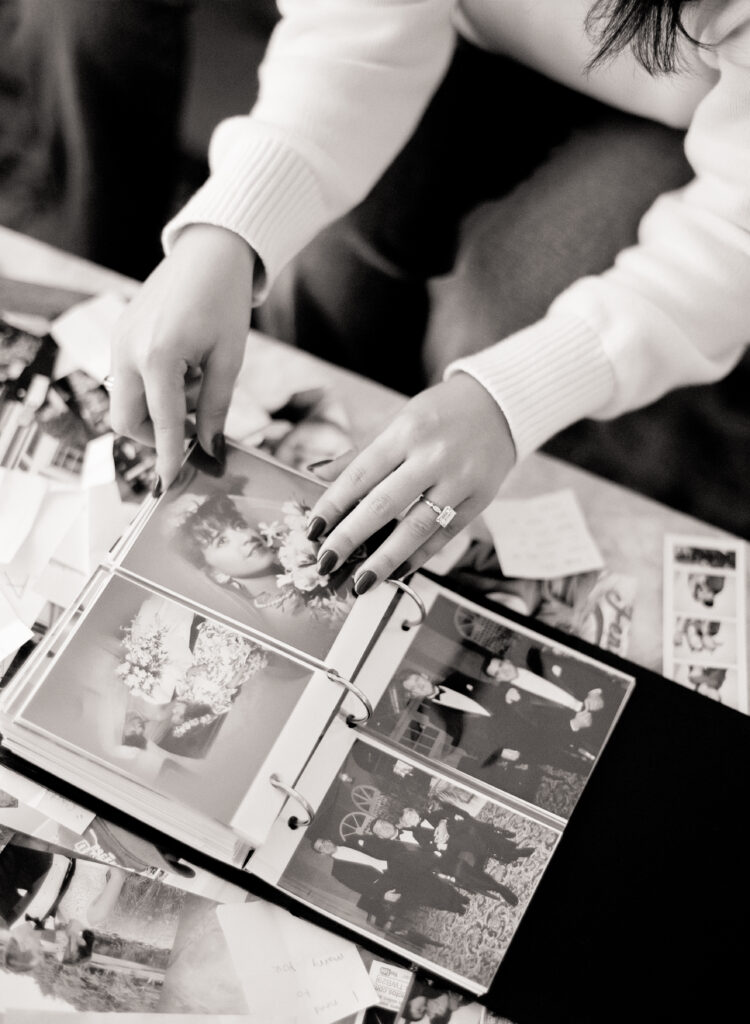 a person looking at a photo album at a engagement shoot on film 