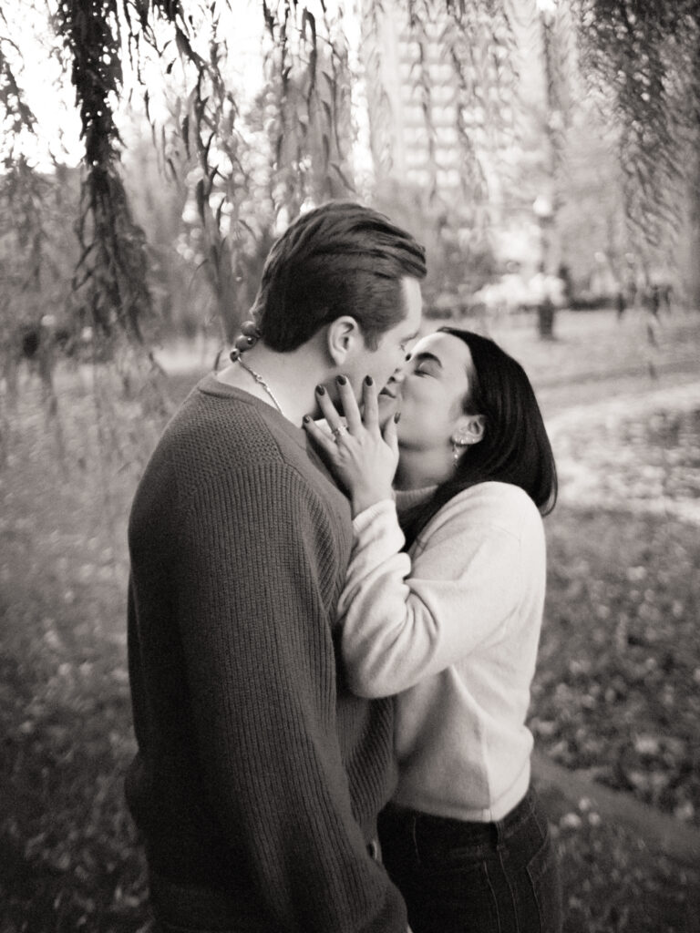 couple kissing under a tree during film engagement photos 