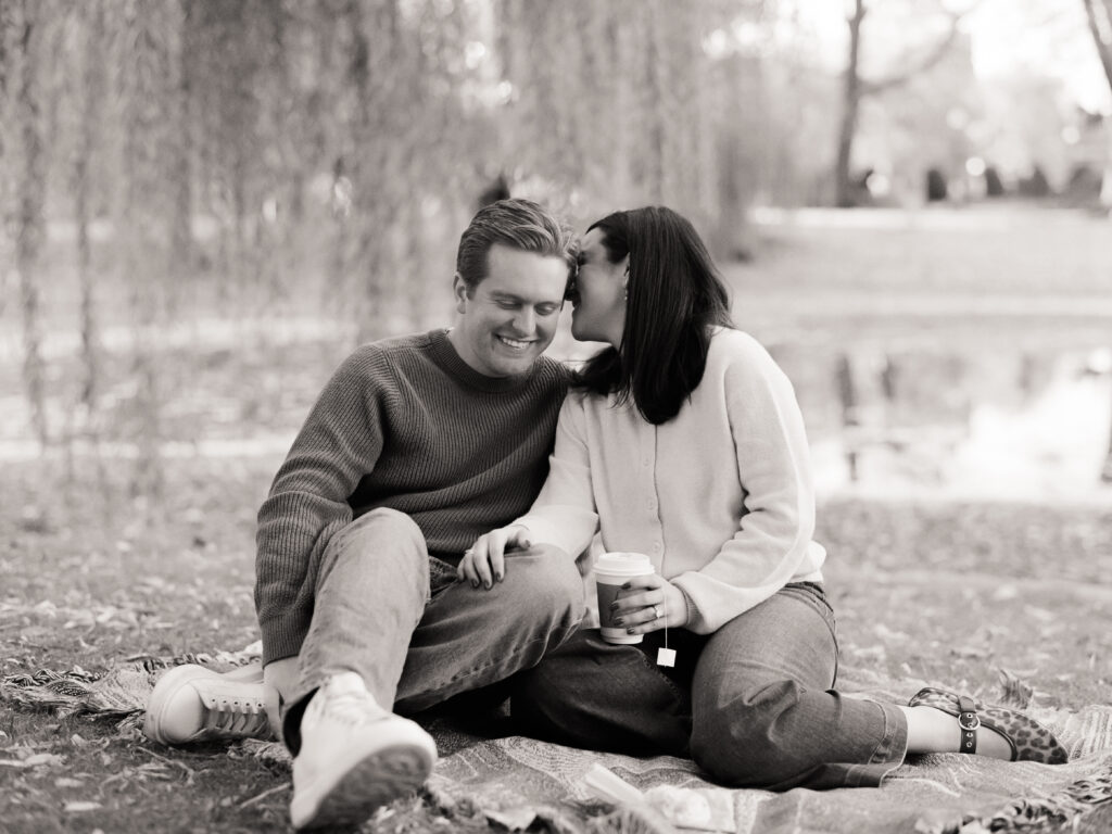 a woman kissing a man sitting on the ground for film engagement photos
