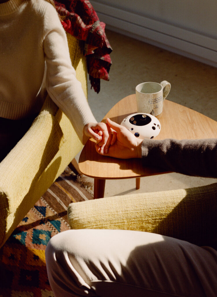 people holding hands on coffee table 