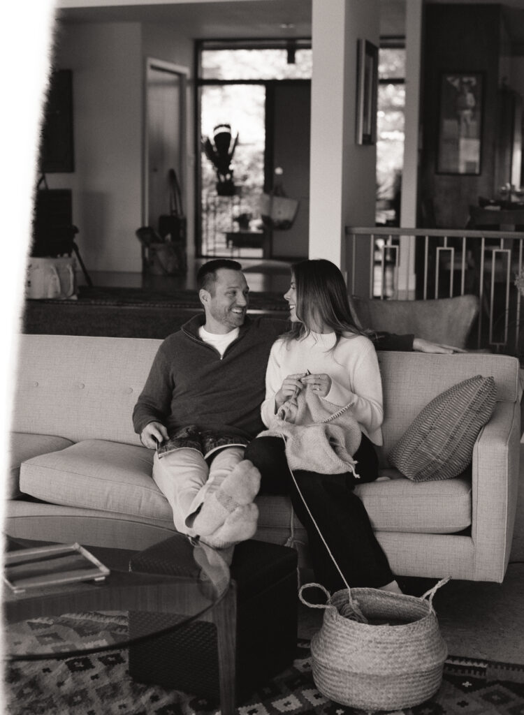 couple sitting on couch knitting and reading 