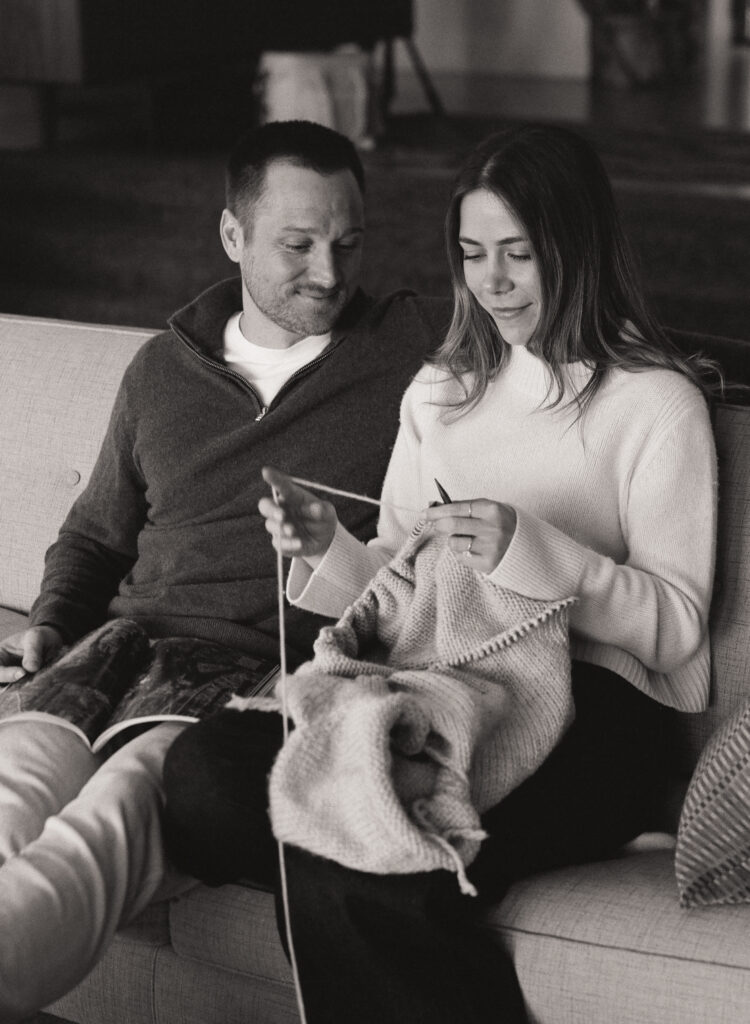 couple sitting on couch knitting and reading 