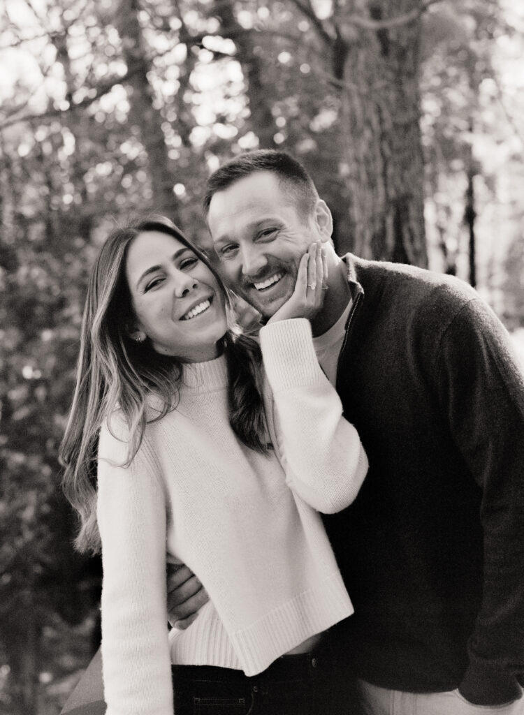 couple during engagement session smiling and holding onto eachother