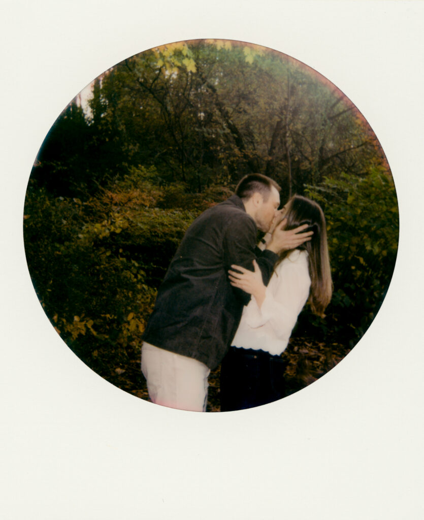 polaroid of couple kissing in woods