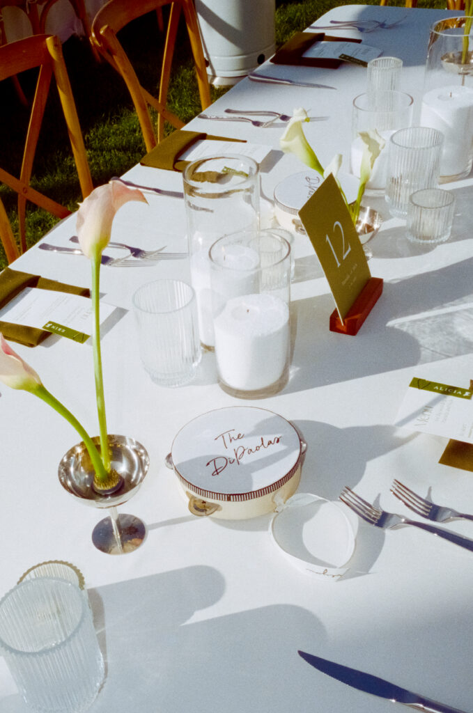 flowers, candles, and place settings on a white tablecloth 
