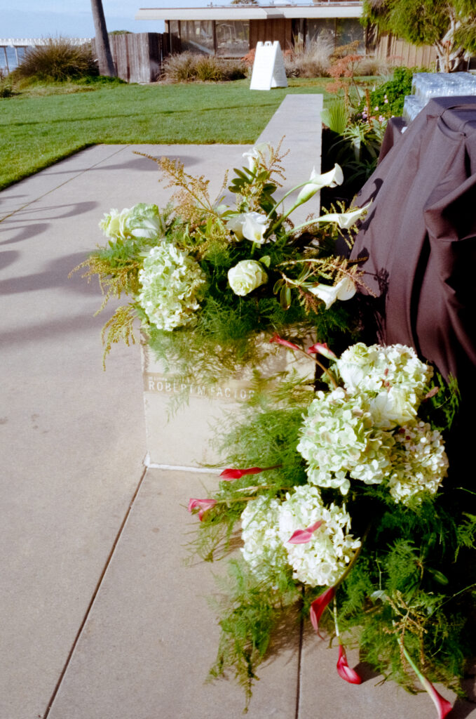 white flowers sitting on steps for a Scripps Seaside Forum wedding 