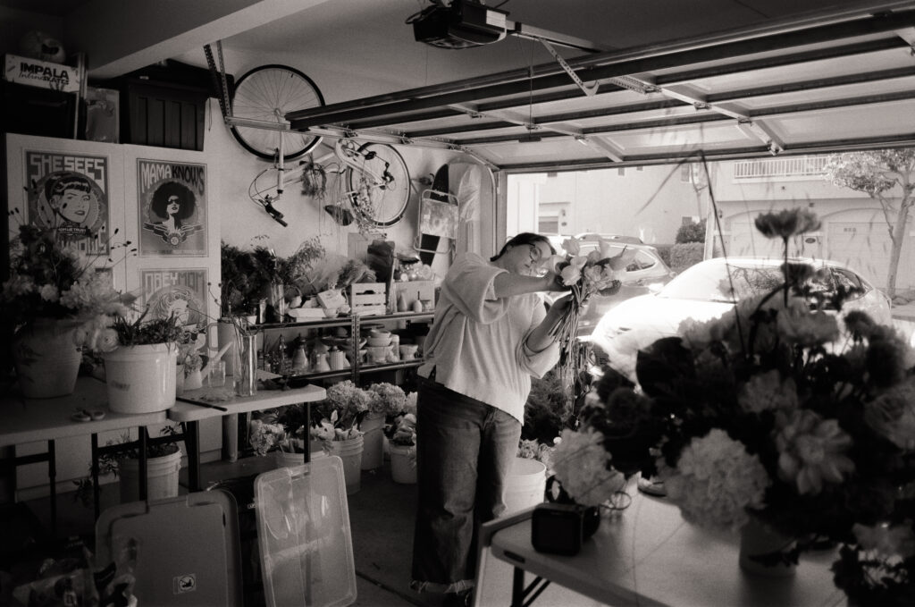 a woman holding flowers in a garage