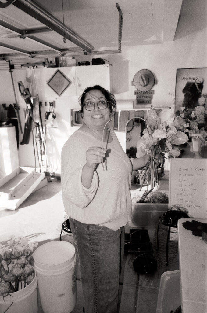 a woman holding a bunch of flowers