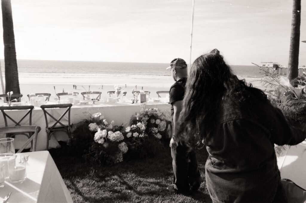 man and woman installing floral arrangements for a wedding at Scripps Seaside forum in San Diego