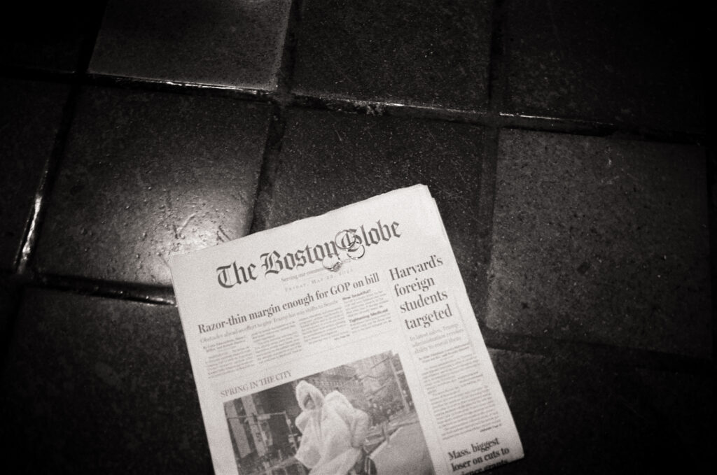 The Boston Globe paper on tile in a black and white photo