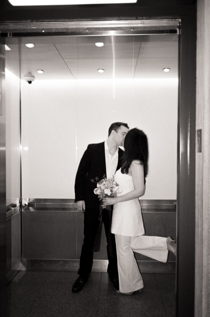 newly married couple kissing in an elevator after their Boston City Hall elopement 